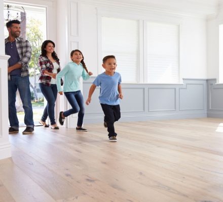 excited family walking into an empty  house